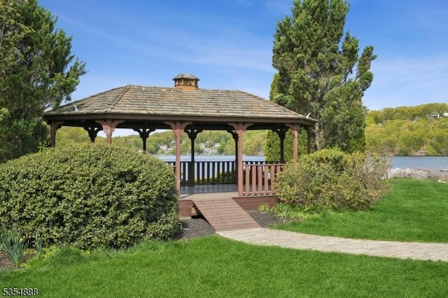 surrounding community featuring a yard, a water view, and a gazebo