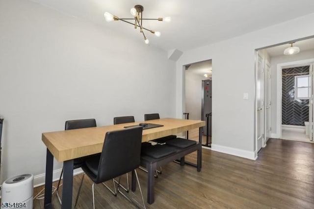 dining space with baseboards, dark wood finished floors, and a notable chandelier