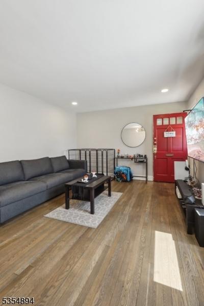 living room with recessed lighting and wood finished floors