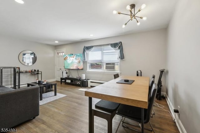 dining space featuring an inviting chandelier, wood finished floors, baseboards, baseboard heating, and recessed lighting