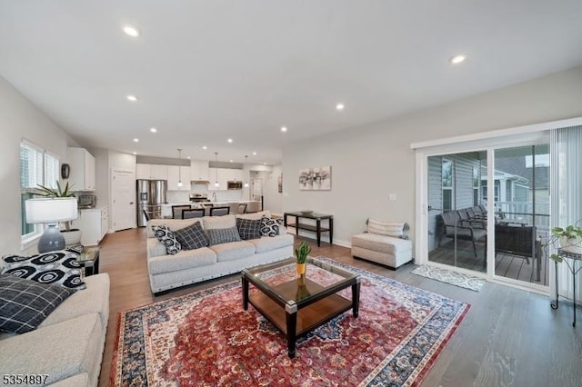 living area with recessed lighting and wood finished floors