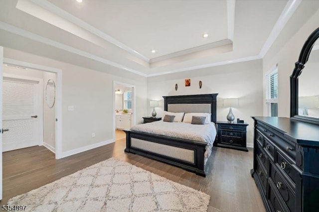 bedroom featuring recessed lighting, a tray ceiling, ornamental molding, and wood finished floors