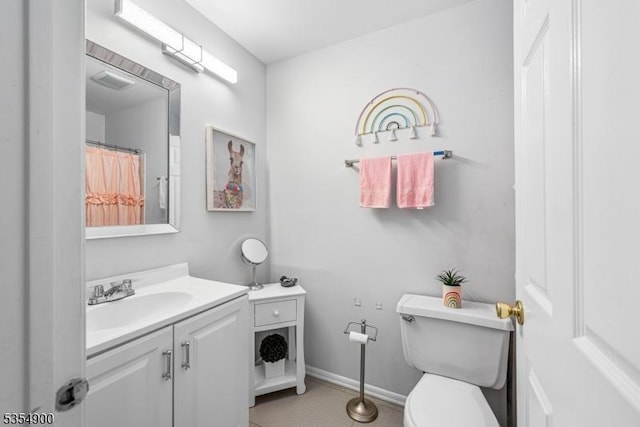 bathroom featuring vanity, baseboards, toilet, and visible vents