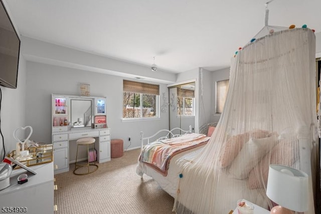 bedroom featuring light carpet