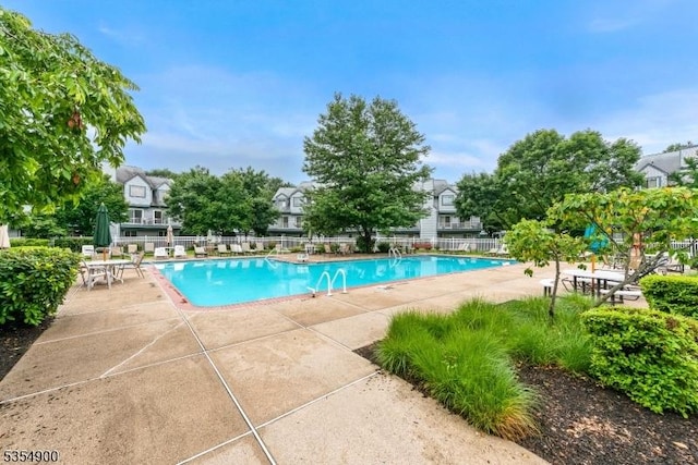 pool featuring a patio and fence