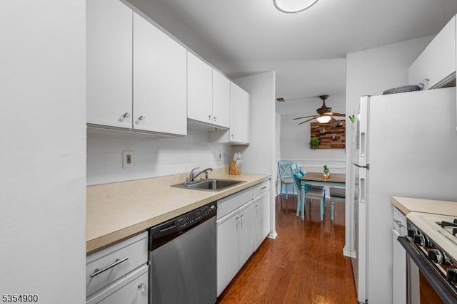 kitchen with a sink, dishwasher, light countertops, a ceiling fan, and dark wood-style floors