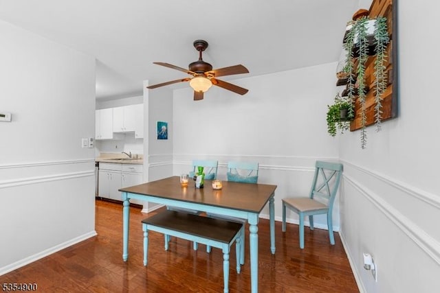 dining area with baseboards, ceiling fan, and wood finished floors