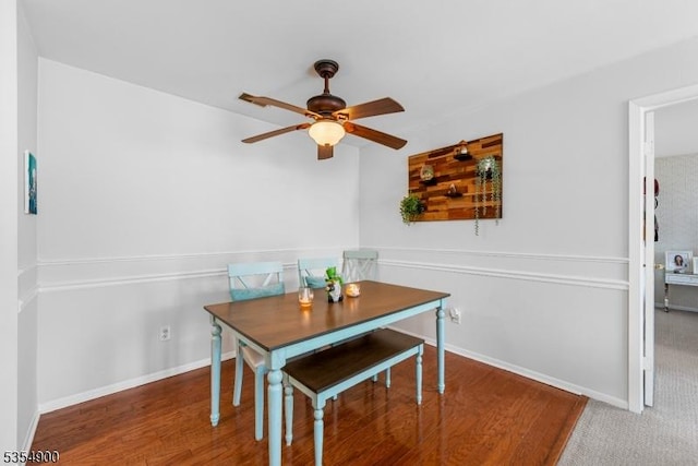 dining space with baseboards and a ceiling fan