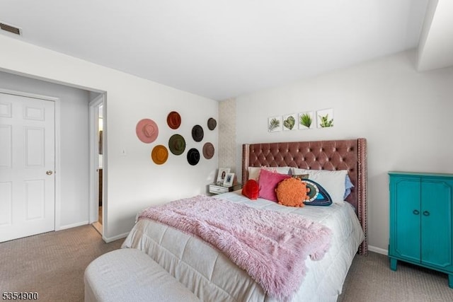 carpeted bedroom with baseboards and visible vents