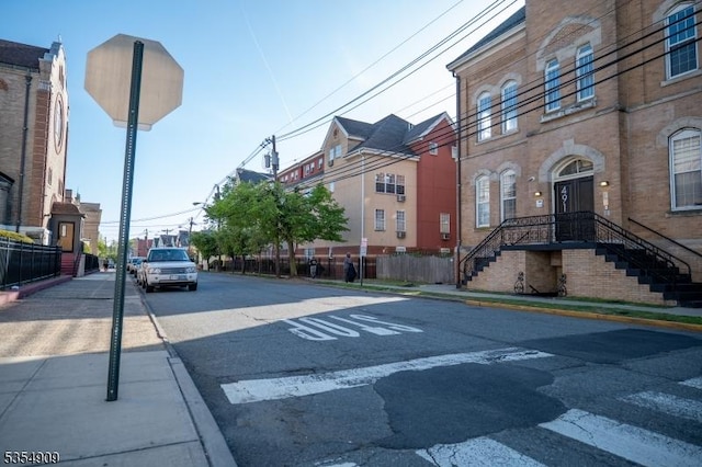 view of street with street lights, sidewalks, and curbs
