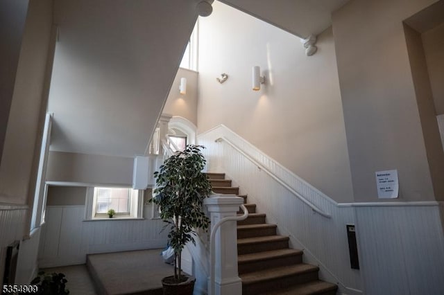 stairs featuring wainscoting