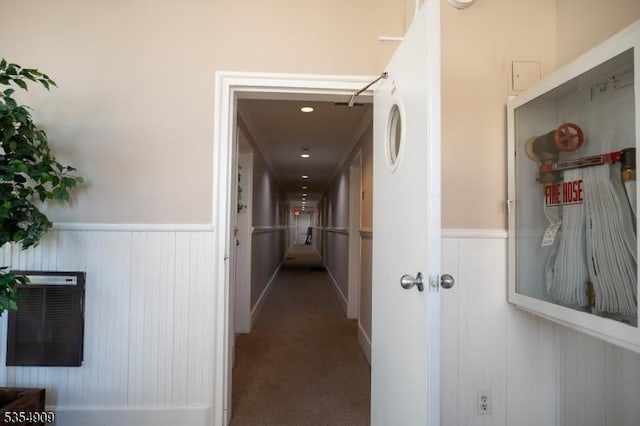 hall with carpet flooring and wainscoting