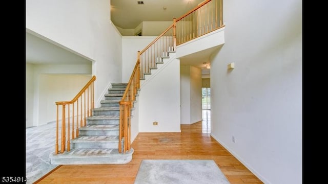 27 Suydam Rd, Franklin Twp, NJ 08873 - stairway with a towering ceiling and wood finished floors