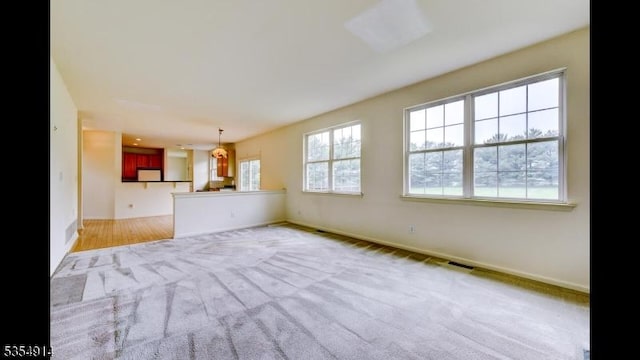 27 Suydam Rd, Franklin Twp, NJ 08873 - unfurnished living room featuring baseboards and carpet floors