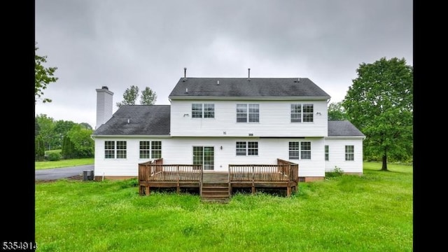 27 Suydam Rd, Franklin Twp, NJ 08873 - back of property featuring a wooden deck, a yard, a chimney, and cooling unit