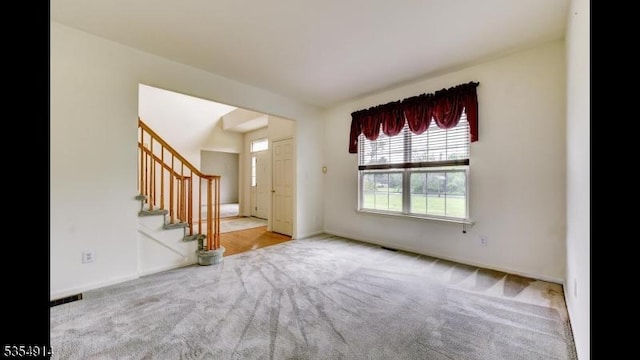 27 Suydam Rd, Franklin Twp, NJ 08873 - unfurnished living room featuring carpet flooring, stairs, and baseboards