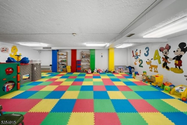 playroom featuring a textured ceiling and visible vents