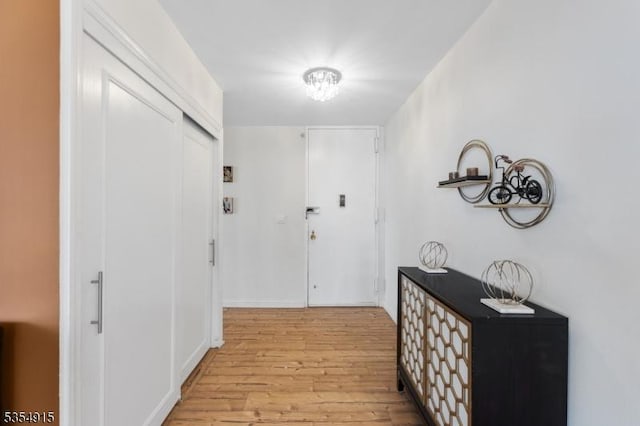 corridor with light wood-type flooring