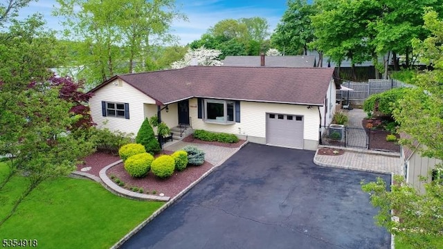 12 Johnson Ave, Hopatcong Boro, NJ 07843 - single story home with an attached garage, asphalt driveway, fence, and a shingled roof