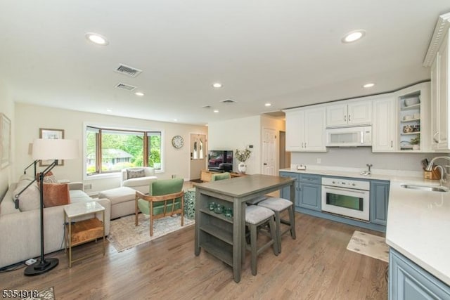 12 Johnson Ave, Hopatcong Boro, NJ 07843 - kitchen with white appliances, open shelves, a sink, open floor plan, and blue cabinets