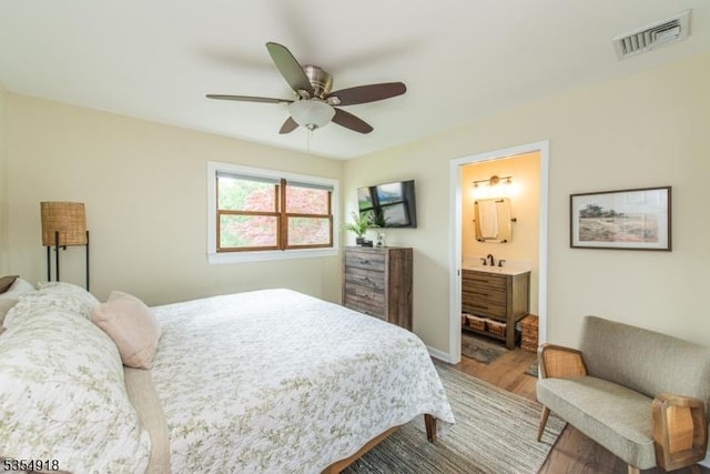 12 Johnson Ave, Hopatcong Boro, NJ 07843 - bedroom with wood finished floors, connected bathroom, a ceiling fan, and a sink