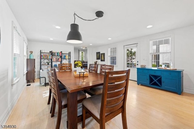 dining space with light wood-style flooring, recessed lighting, and baseboards