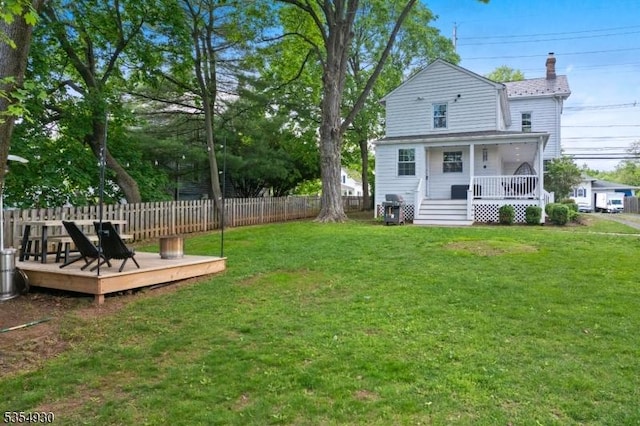 view of yard featuring a wooden deck and a porch
