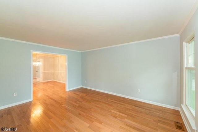 70 Crenshaw Dr, Mount Olive Twp, NJ 07836 - spare room featuring ornamental molding, a chandelier, and light wood finished floors