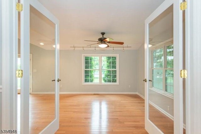 70 Crenshaw Dr, Mount Olive Twp, NJ 07836 - spare room with a ceiling fan, light wood-style floors, track lighting, and french doors