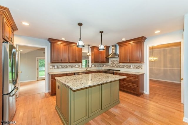 70 Crenshaw Dr, Mount Olive Twp, NJ 07836 - kitchen with stainless steel appliances, wall chimney range hood, backsplash, light wood finished floors, and a kitchen island