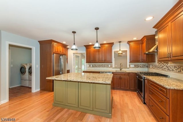 70 Crenshaw Dr, Mount Olive Twp, NJ 07836 - kitchen featuring appliances with stainless steel finishes, washer and dryer, wall chimney exhaust hood, tasteful backsplash, and recessed lighting