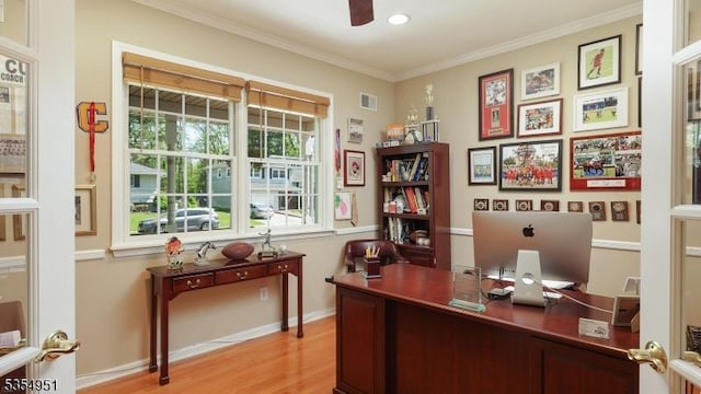 home office with visible vents, a ceiling fan, wood finished floors, and ornamental molding