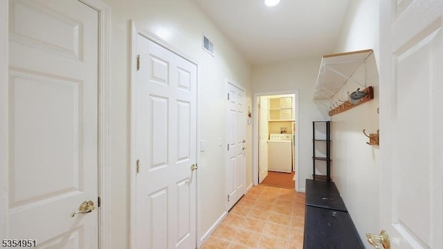 hall featuring washer / clothes dryer, recessed lighting, visible vents, and light tile patterned floors