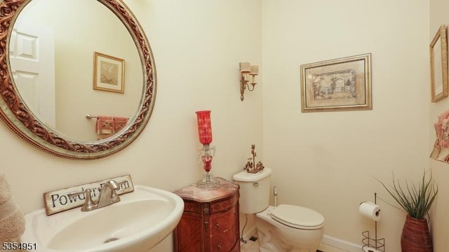 half bathroom with a sink and toilet