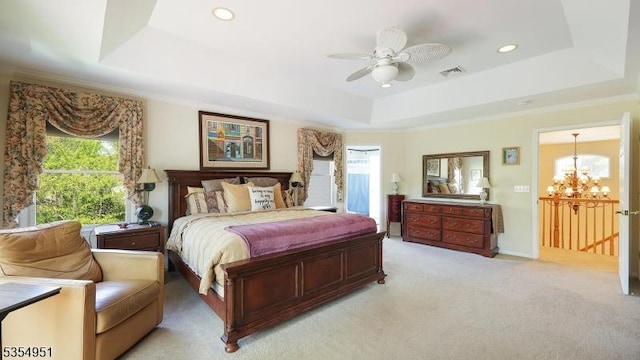 bedroom with visible vents, ornamental molding, recessed lighting, light colored carpet, and a tray ceiling