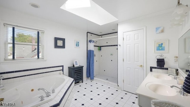 full bathroom featuring a sink, a skylight, a whirlpool tub, and a shower stall