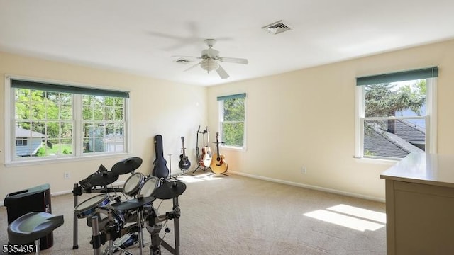exercise area with a ceiling fan, baseboards, visible vents, and carpet