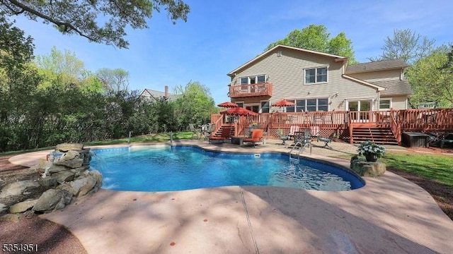 pool featuring a patio area, a deck, and stairway