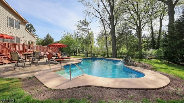 view of pool featuring a fenced in pool, fence, a patio, and a deck