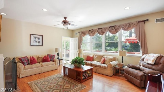 living room with ceiling fan, recessed lighting, and visible vents
