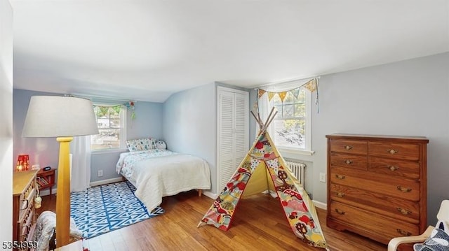 bedroom featuring baseboards, a closet, and wood finished floors