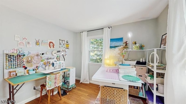 office space with baseboards and wood finished floors