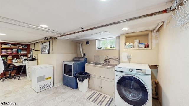 laundry area with cabinet space, recessed lighting, a sink, and washer and clothes dryer