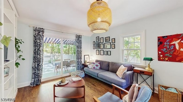 living area featuring baseboards and wood finished floors