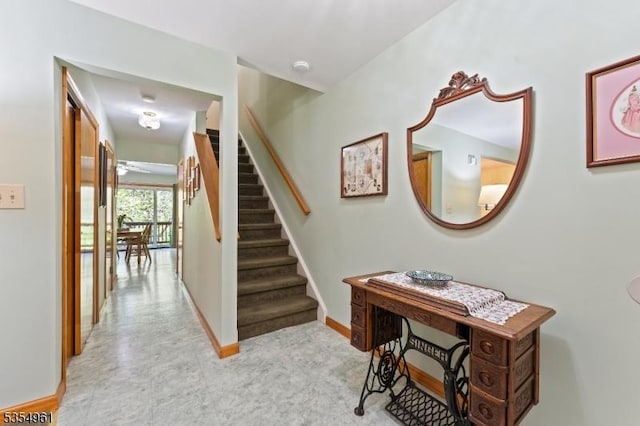 staircase featuring baseboards