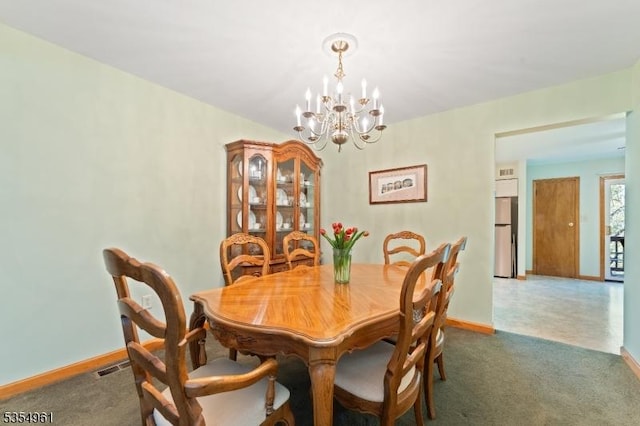 carpeted dining space with baseboards, a notable chandelier, and visible vents