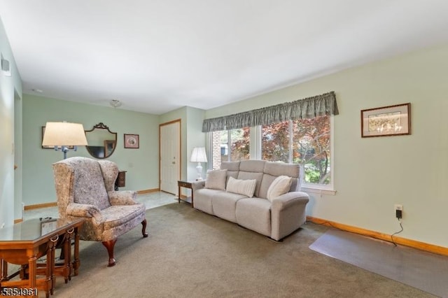 carpeted living room with baseboards