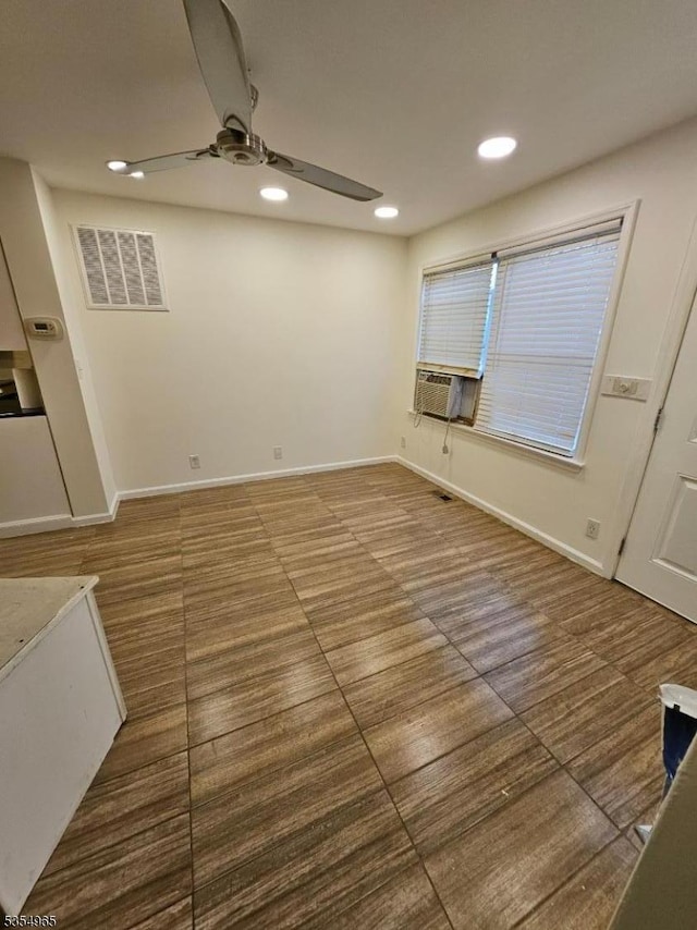 unfurnished room with a ceiling fan, recessed lighting, cooling unit, and baseboards