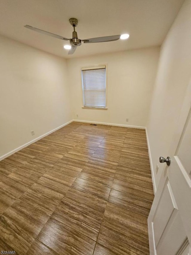 empty room with a ceiling fan, recessed lighting, and baseboards