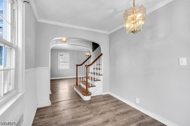 123 Robbinwood Ter, Linden City, NJ 07036 - entryway featuring a chandelier, arched walkways, wood finished floors, and ornamental molding